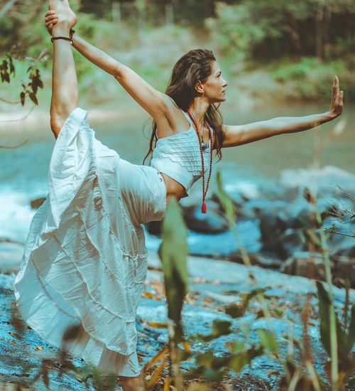 Woman in a graceful yoga stretch outdoors.